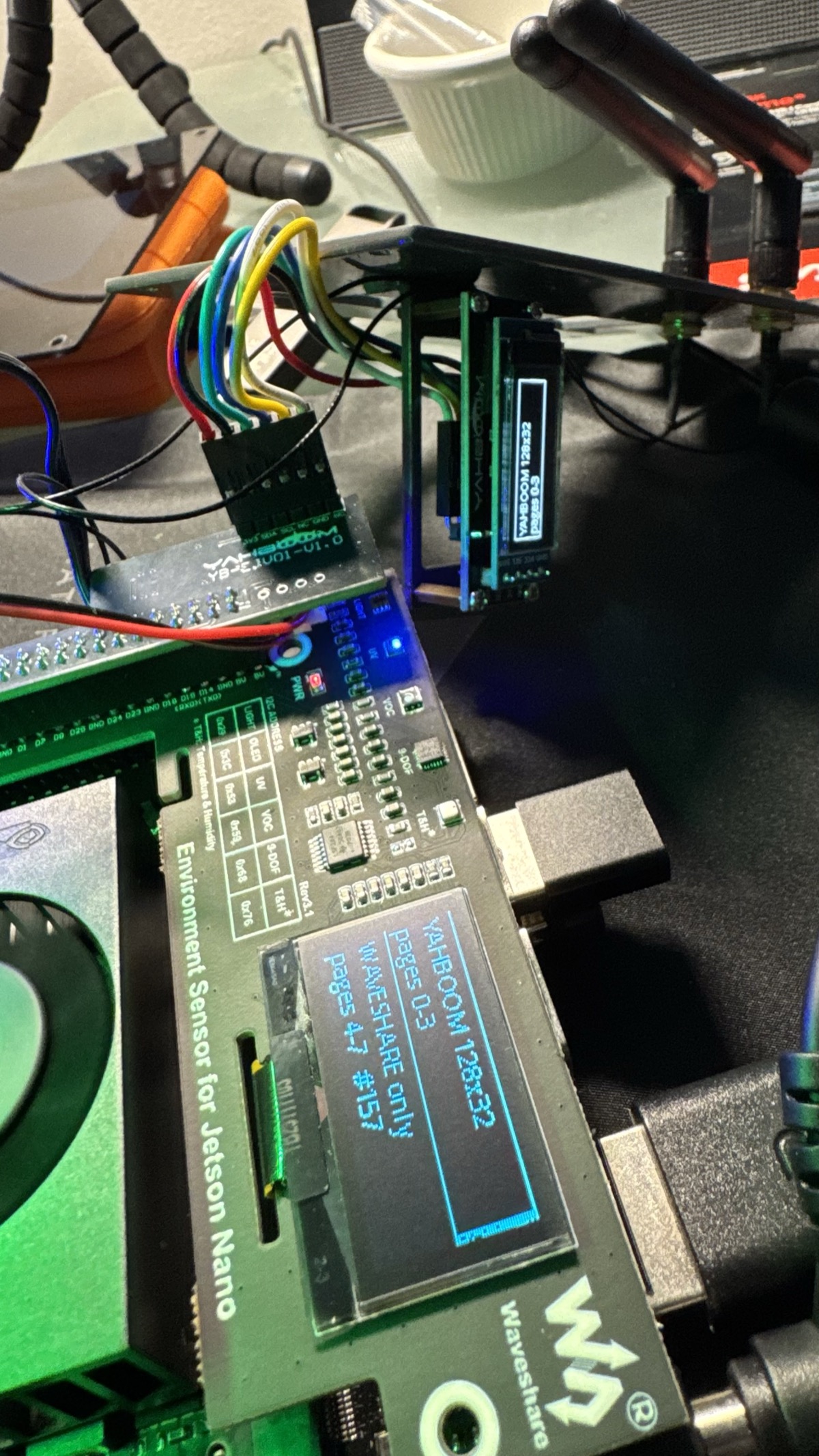 Both OLEDs lit at once on the stacked Jetson Orin Nano — Yahboom SSD1306 128x32 and Waveshare SH1106 128x64 on one I2C address